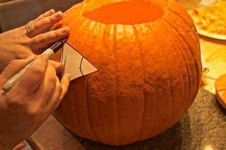 Carving out the Halloween pumpkin eye