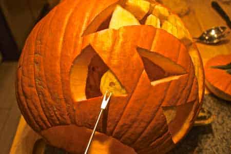 Carving out the Halloween pumpkin eye